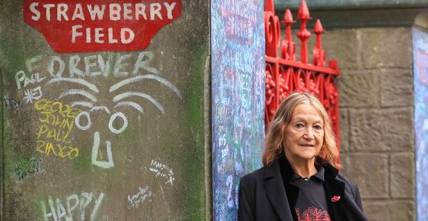 Honorary President of the 'Strawberry Field Project', Julia Baird poses in front of the gates