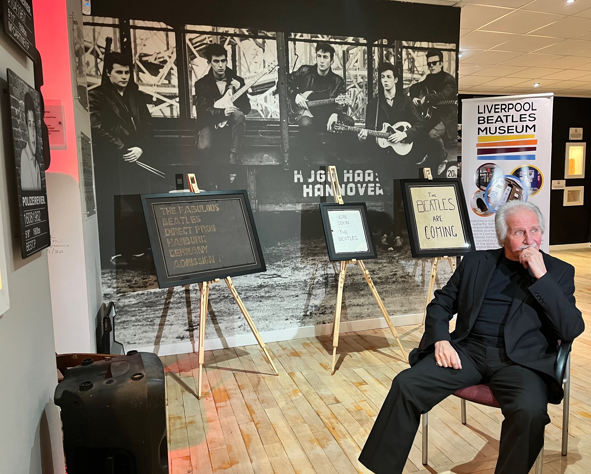Pete Best with the new exhibit, his friend Neil's three posters